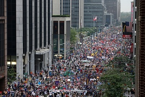 Demonstrators make their way down Sixth Avenue